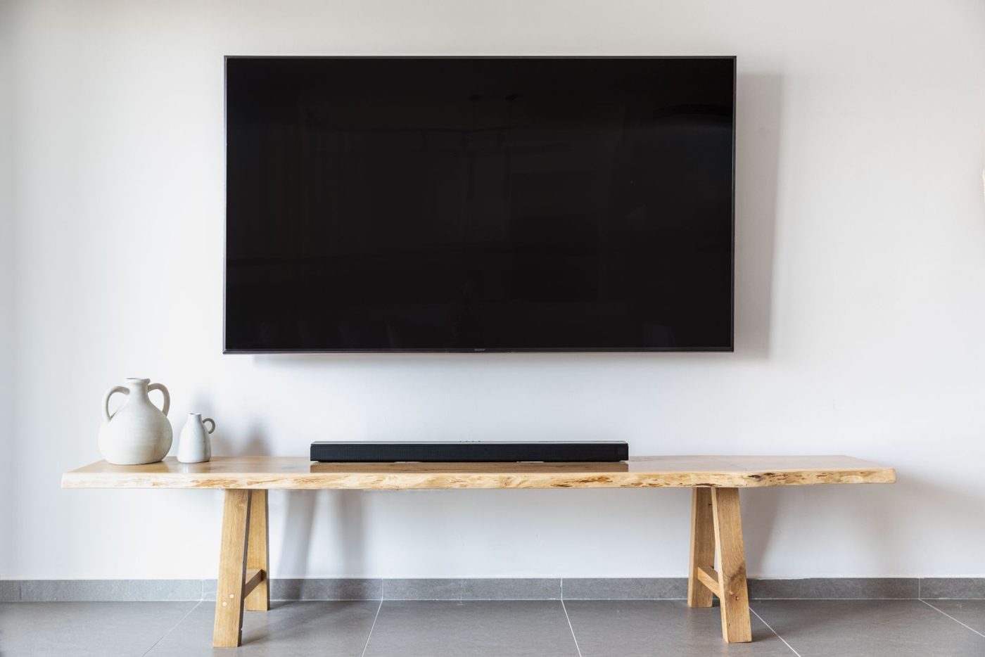 A smart TV mounted above a media console